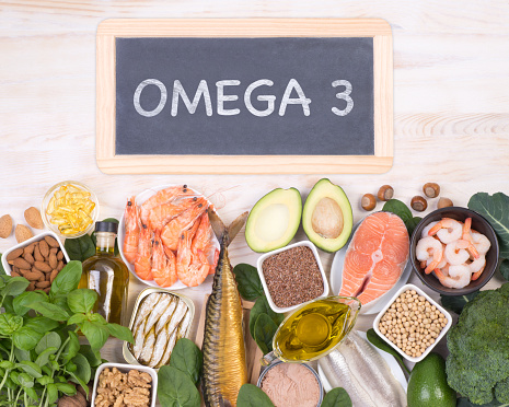 Food rich in Omega 3 fatty acids, top view with a small blackboard