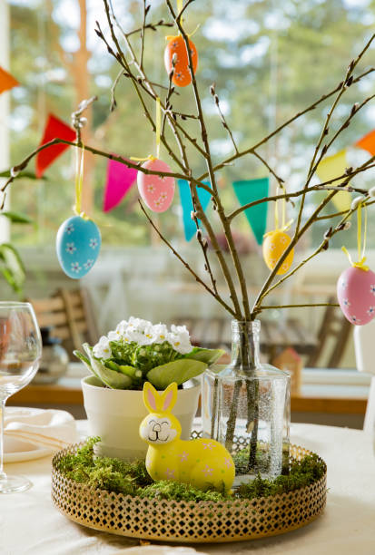 Beautiful served round table with decorations in dining room for Easter celebration