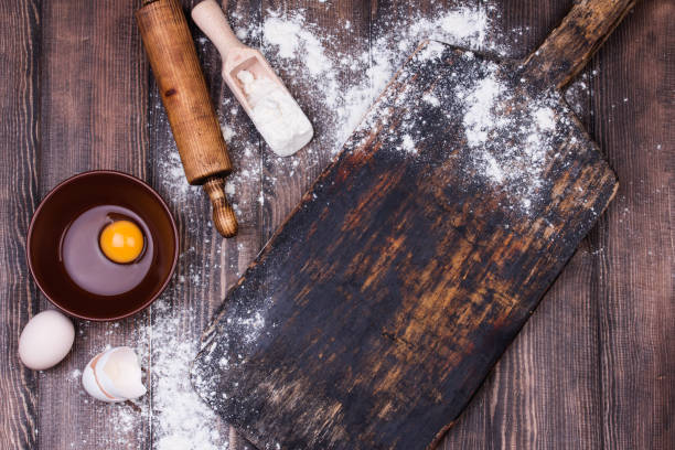 istock Rolling pin and flour on black table. Copy space. Top view 926291290