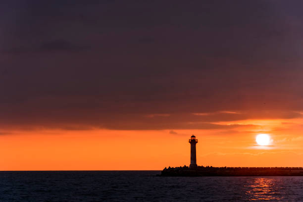 istock seascape of a Lighthouse at sunrise 926292198