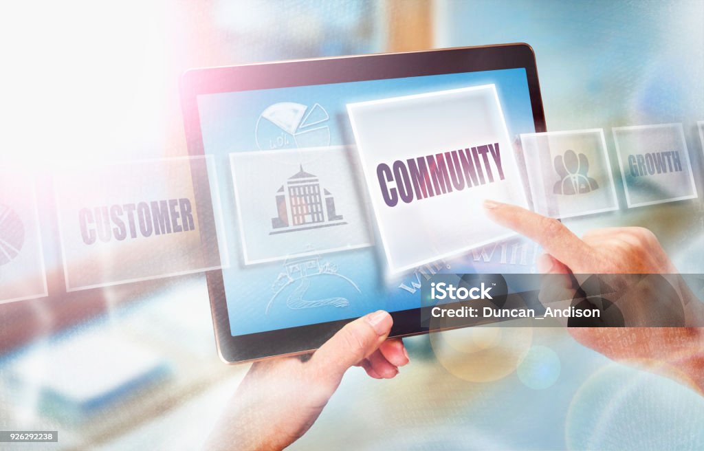 Community business concept A businesswoman selecting a Community business concept on a futuristic portable computer screen. Non-Profit Organization Stock Photo