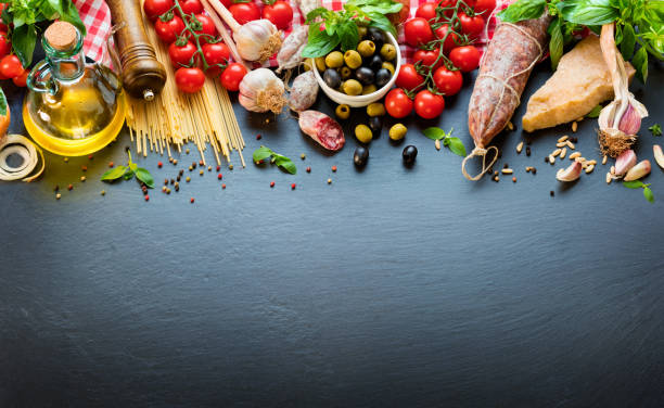 Italian Food Ingredients On Dark Table With Spaghetti, Tomato And Cheese Italian Food Ingredients On Dark Slate mediterranean food stock pictures, royalty-free photos & images