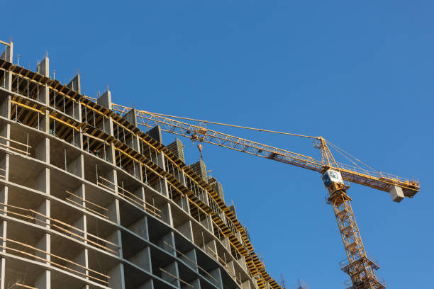 istock yellow construction crane works near the house under construction 926307308