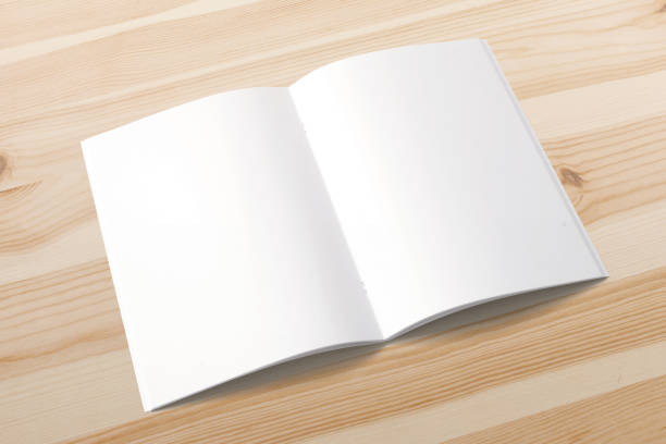 istock Opened magazine on wooden background. Blank pages .. 926308088