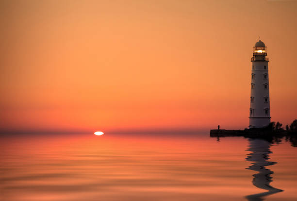 istock Lighthouse searchlight beam near ocean at sunset 926308898