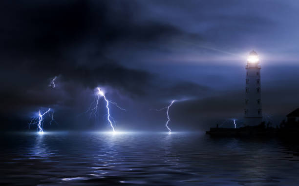 istock lighthouse in a storm. Thunderstorm over the sea, lightning beats the water 926309160