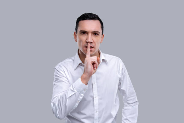 istock Determined man having his index finger near his lips 926316442