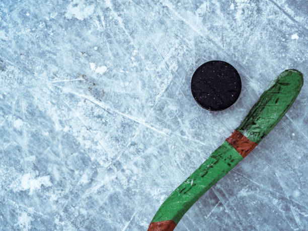 hockey puck and stick on the ice texture, copyspace and text