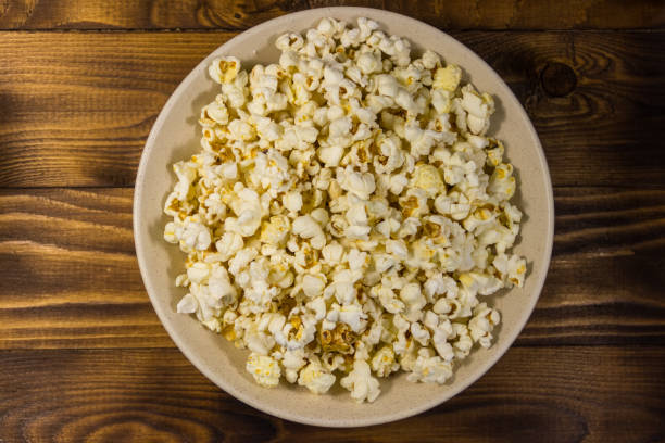istock Bowl with popcorn on wooden table 926316540