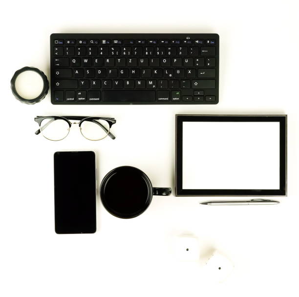 istock Black frame mockup with interior items and keyboard, smartphone, cup of coffee, glasses and supplies on black and white background 926321430