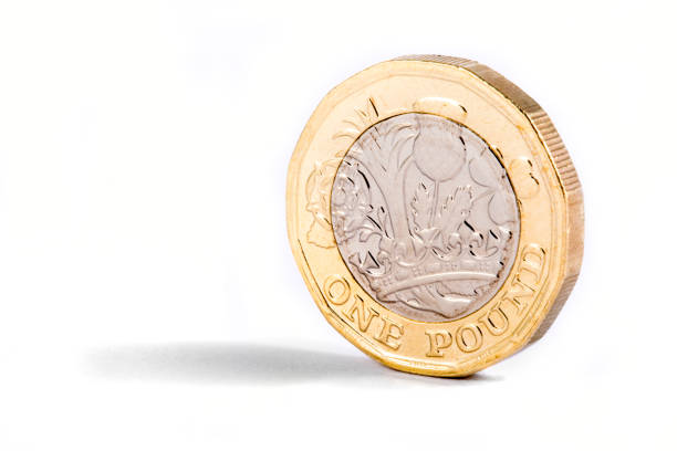 One Pound Coin A close-up shot of the new British one pound coin over a white background. one pound coin photos stock pictures, royalty-free photos & images