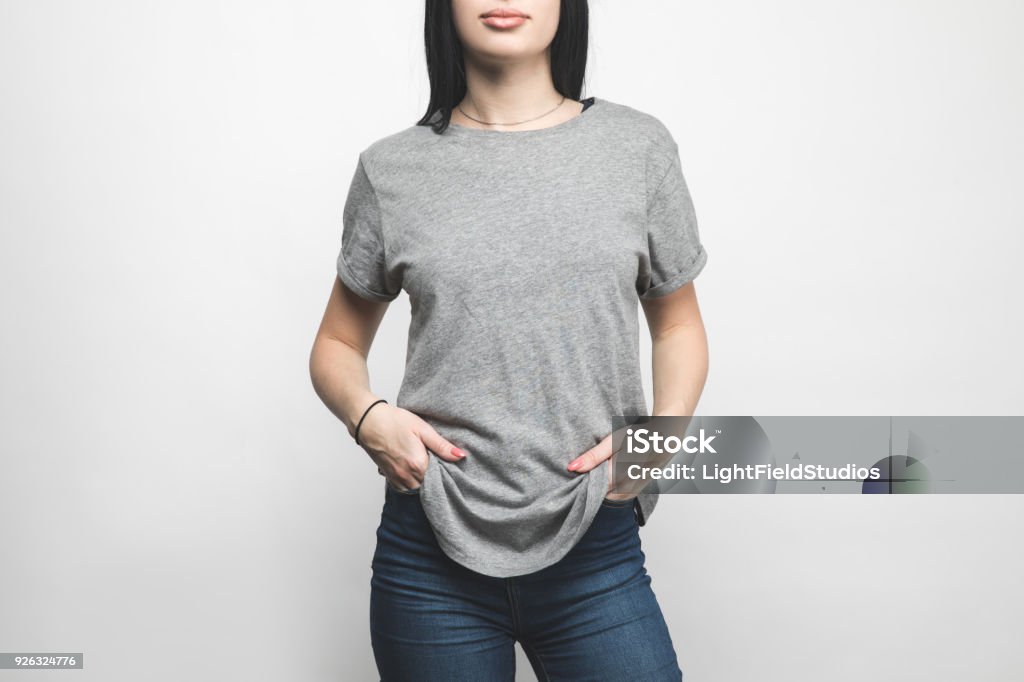 cropped shot of young woman in blank grey t-shirt on white T-Shirt Stock Photo