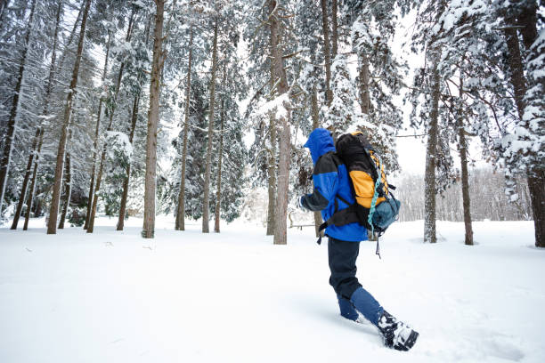 istock Young male backpacker hiking away from the camera through deep snow 926325466