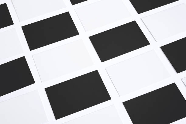 istock Black and white business cards in checkerboard order isolated on white. Image. 926325494