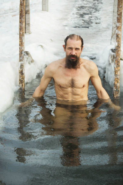 istock A middle-aged man is immersed in an ice hole. 926334774