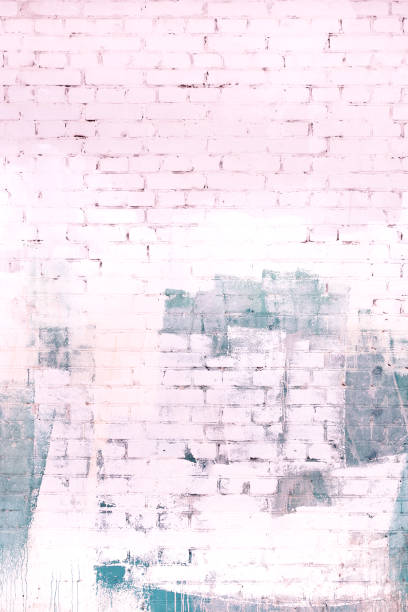 istock The brick wall is painted in an abstract gray and pale pink paint. Background, texture. 926346706