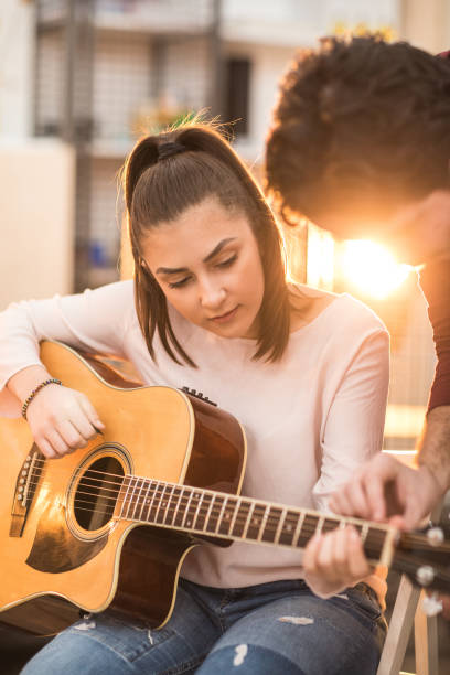 istock Young woman learning to play the guitar 926350196