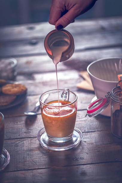 istock Pouring Milk into Cup of Coffee 926350738