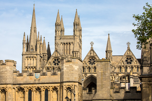 A view of the towers and spires of Peterborough Cathedral above the Norman Gate in the historic city of Peterborough in Cambridgeshire, UK.