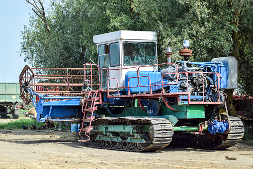 Rice header combine harvester. Old rusty combine harvester. Combine harvesters Agricultural machinery