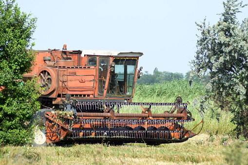 Old rusty combine harvester. Combine harvesters Agricultural machinery. The machine for harvesting grain crops.
