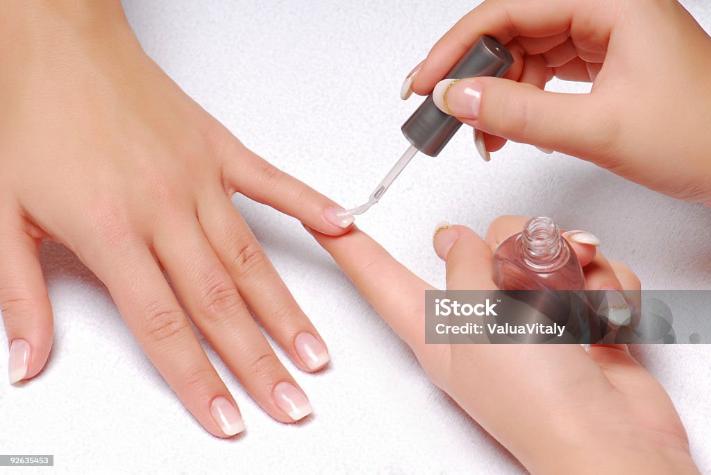 Female Hands Painting A Womans Nails With Clear Varnish Stock Photo -  Download Image Now - iStock