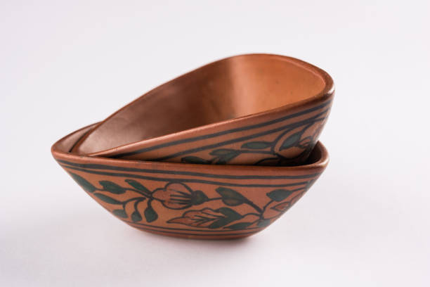 Empty terracotta bowl or brown clay serving bowl isolated on white