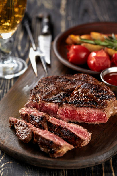 istock Juicy steak medium rare beef with spices on wooden board on table 926362834