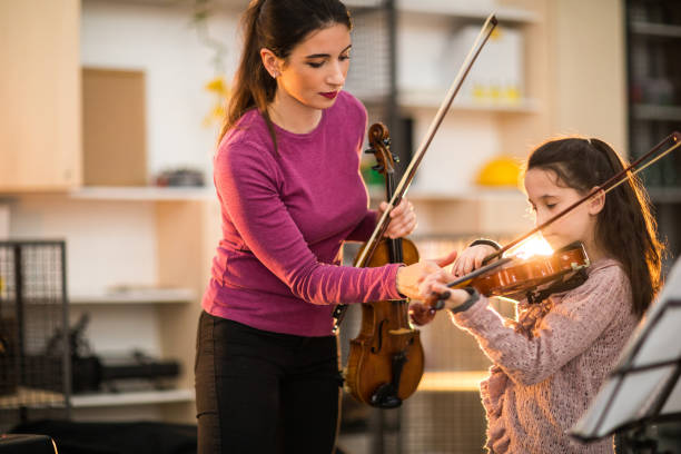 istock Playing the violin with my teacher 926366254