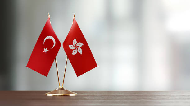 istock Turkish And Hong Kong Flag Pair On A Desk Over Defocused Background 926367818