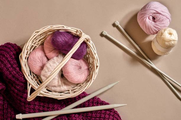 istock Balls of woolen threads and knitting needles. Scandinavian style. Threads for knitting in a basket 926369302