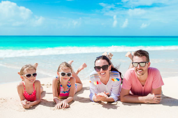istock Happy beautiful family on white beach having fun 926369958
