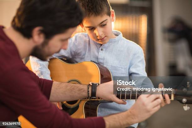 Playing The Guitar With My Brother Stock Photo - Download Image Now - Learning, Guitar, Music