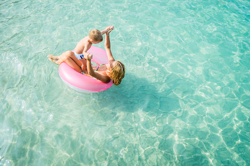 Mother and son enjoy sea water.