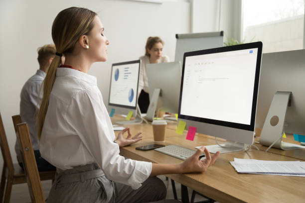 istock Calm peaceful businesswoman meditating at office work desk, side view 926375596