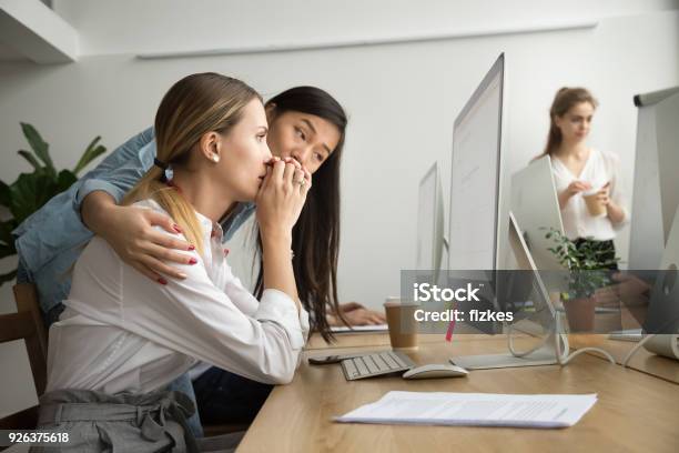 Asian Colleague Supporting Caucasian Coworker Reading Bad News In Email Stock Photo - Download Image Now