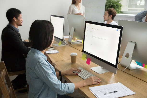 istock Multiracial colleagues working together on desktop computers in corporate office 926375644