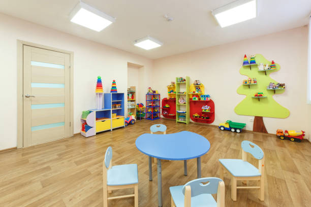 istock Blue table for classes with children and light pink colored game room with in the kindergarten 926379142