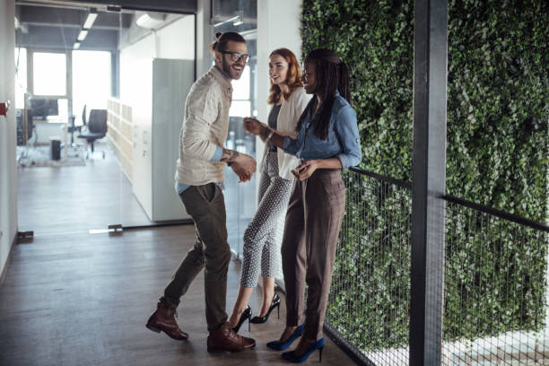 istock Colleagues having fun on a break standing in a hallway 926379256
