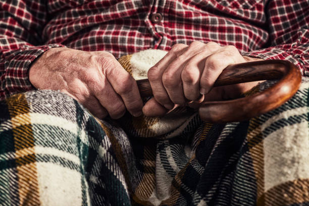 istock An old man's arthritic hands holding onto a cane in his lap 926379838