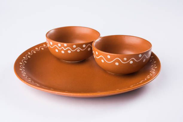 Empty terracotta bowl or brown clay serving bowl isolated on white