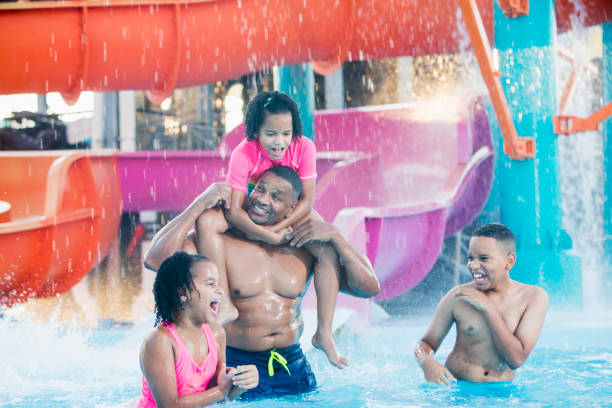 istock African-American father, three children at water park 926389874