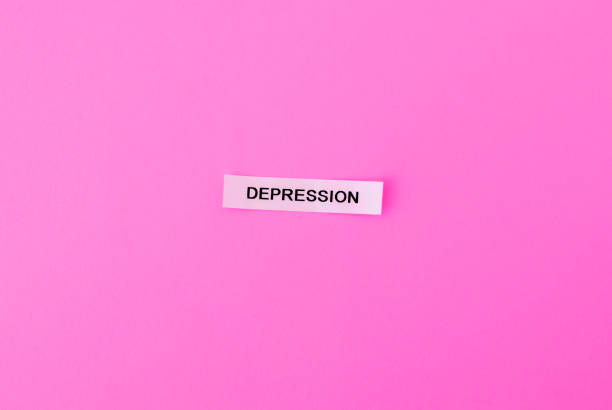 word depression on sticky note on pink background. mental health, problems, people stock photo