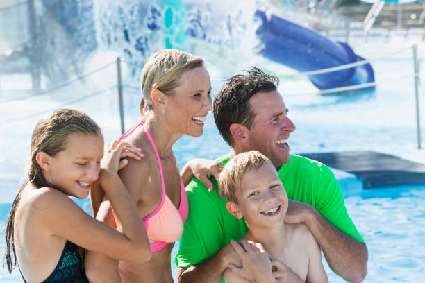 istock Boy with his family having fun at water park 926393234