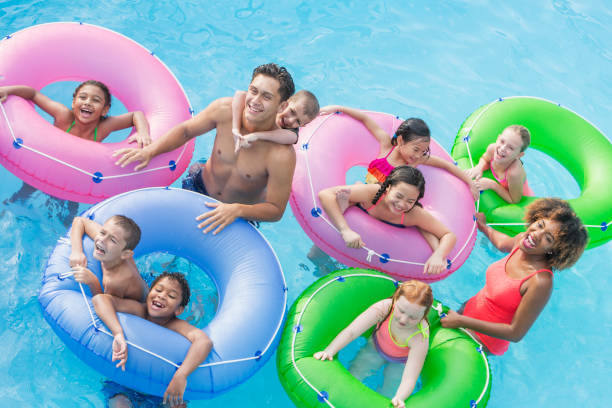 istock Multi-ethnic children, fun on lazy river at water park 926393522