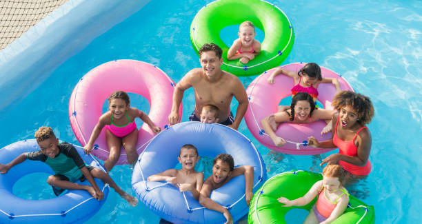 istock Multi-ethnic children, fun on lazy river at water park 926393570