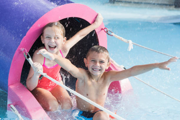 istock Children on water slide grinning at camera 926395968