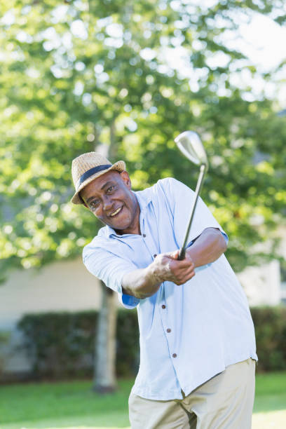 istock Senior African-American man practicing golf swing 926397506