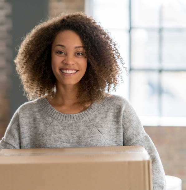istock Happy woman packing and moving house 926397948