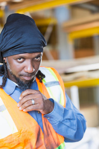 istock Black man working in warehouse wearing safety vest 926398474